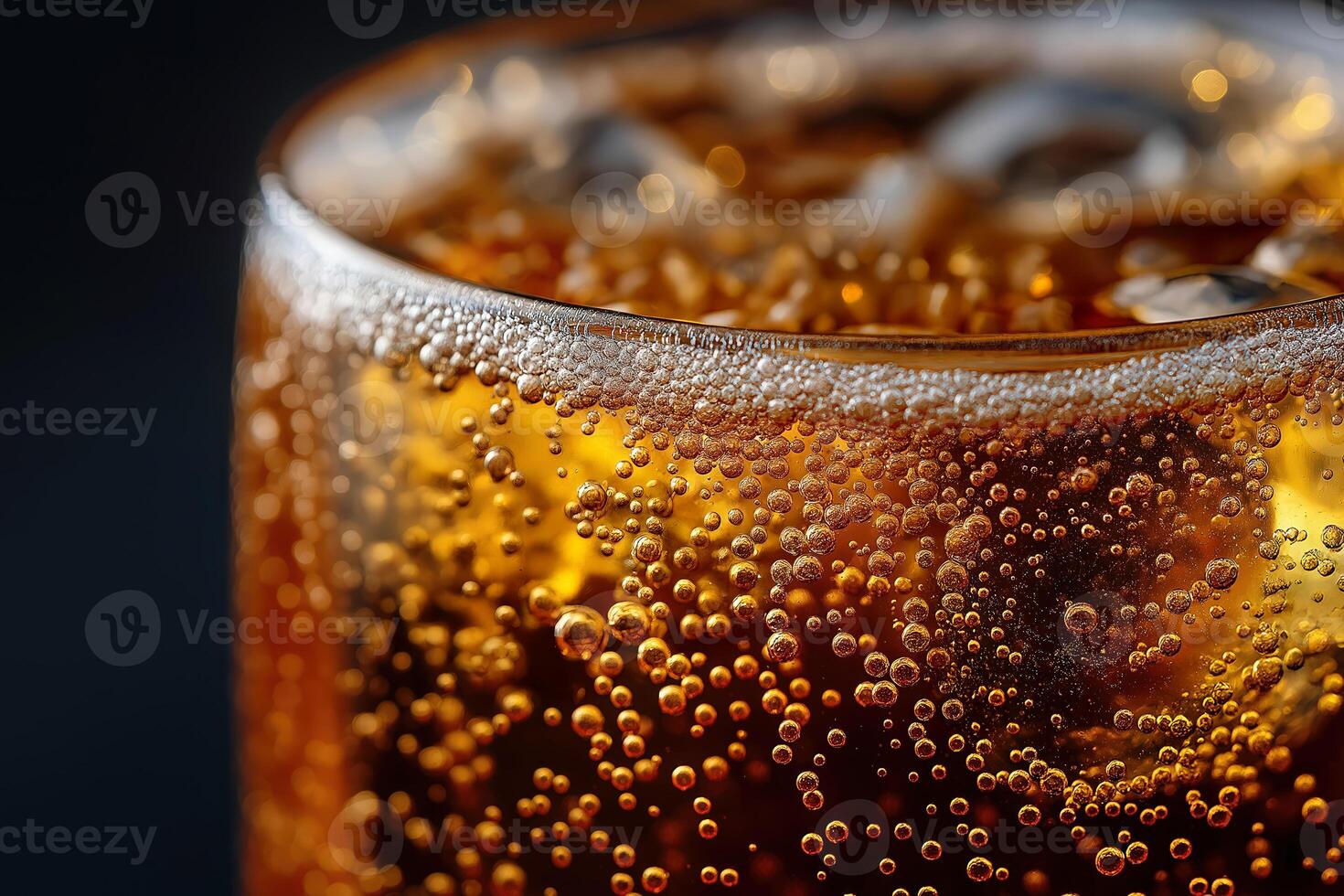 Glass of sparkling cold soda with ice and bubbles on dark background photo