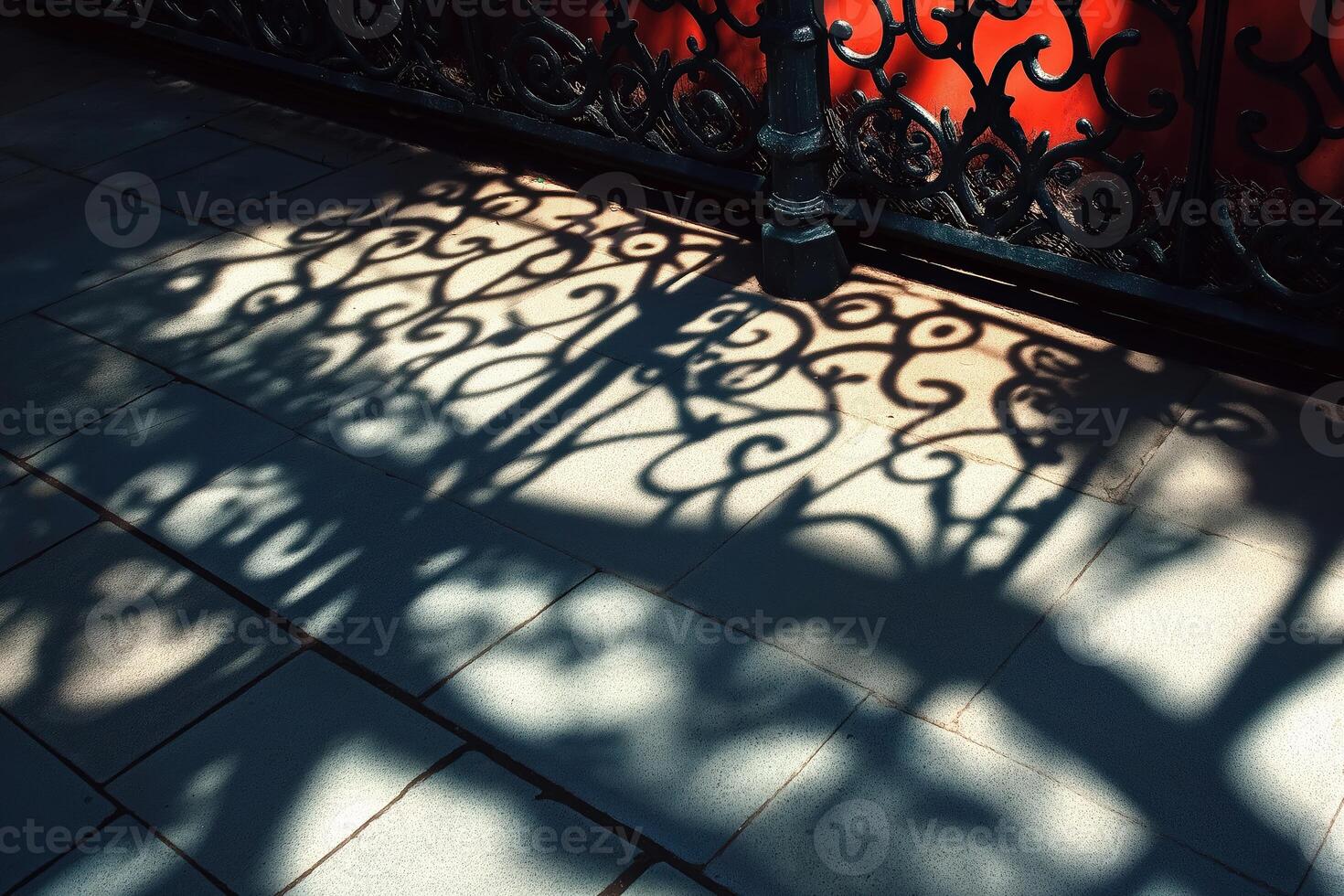 Wrought iron gate casting shadow on tiled floor photo