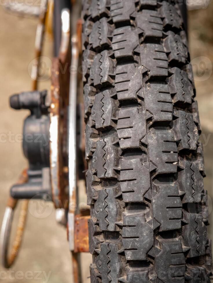 an old and Vintage motorbike tire showing tread and rust photo