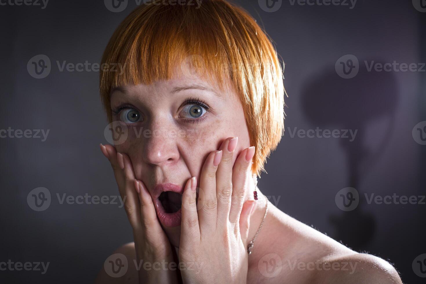 moscow, russia, 14.06.2017 A woman with red hair and a surprised expression on her face photo