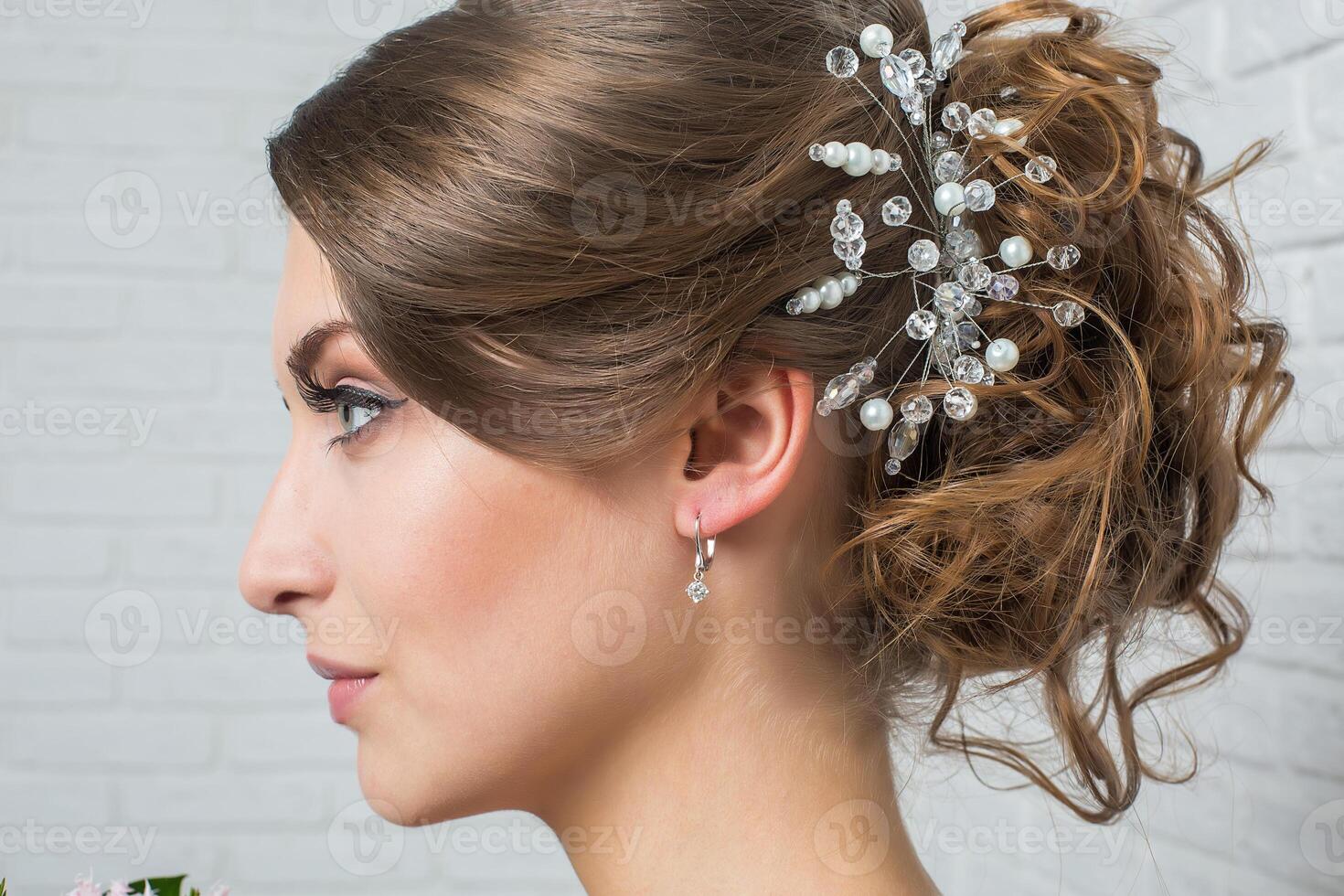 moscow, russia, 28.02.2015 A woman with a beautiful hairstyle and earrings photo