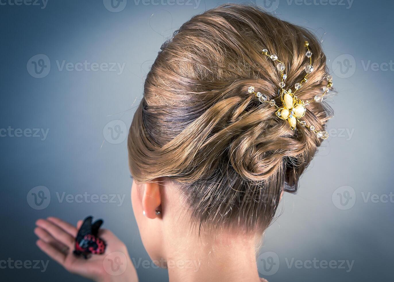 A woman with a beautiful hairstyle and a gold flower clip photo