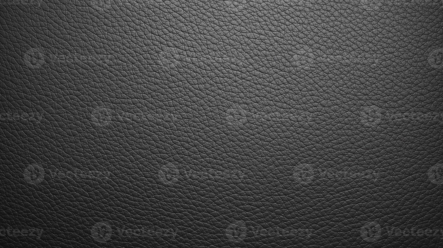 Textured black leather background with a natural grain pattern, showcasing the intricate details and depth of the material, ideal for design and creative projects photo