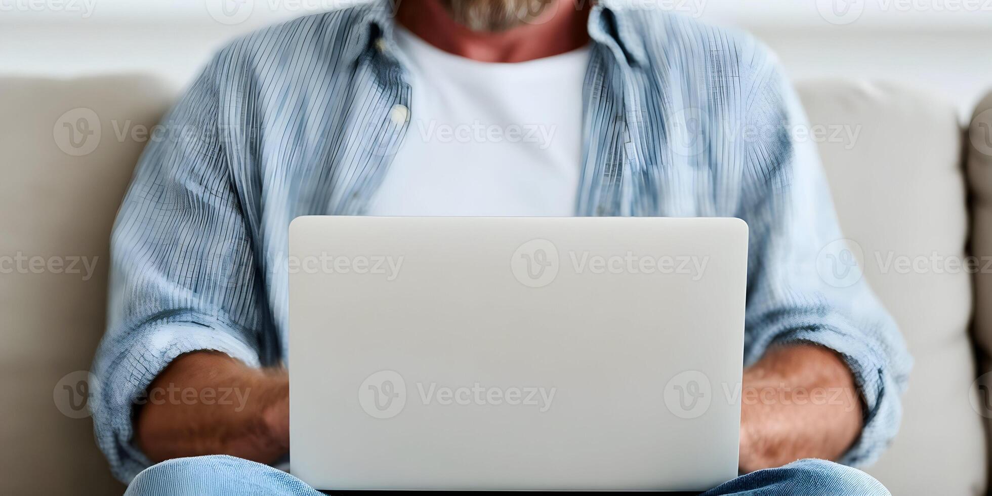 Man Using Laptop Computer on Beige Sofa Casual Home Setting photo