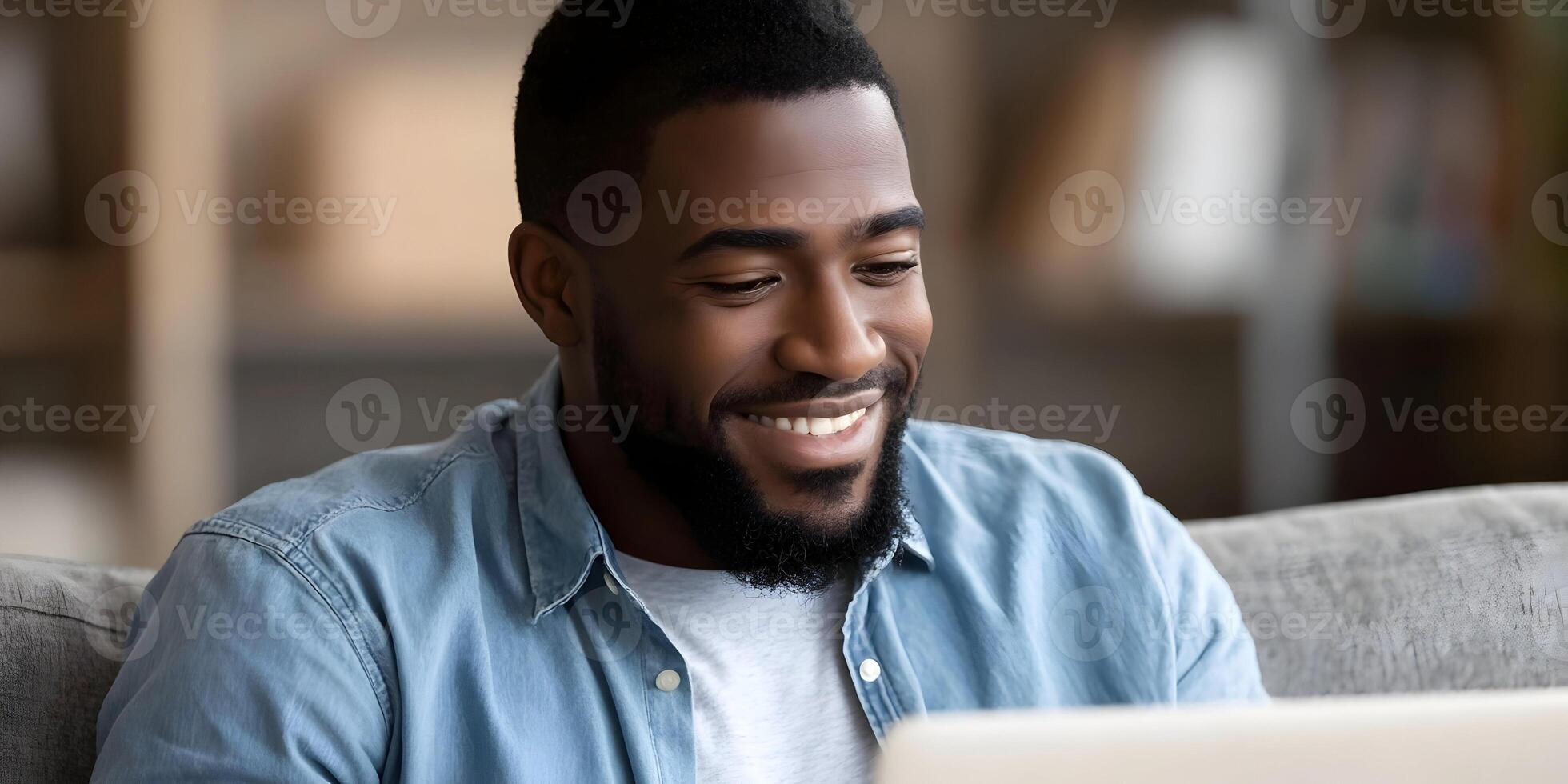 Smiling African American Man Using Laptop Computer at Home photo