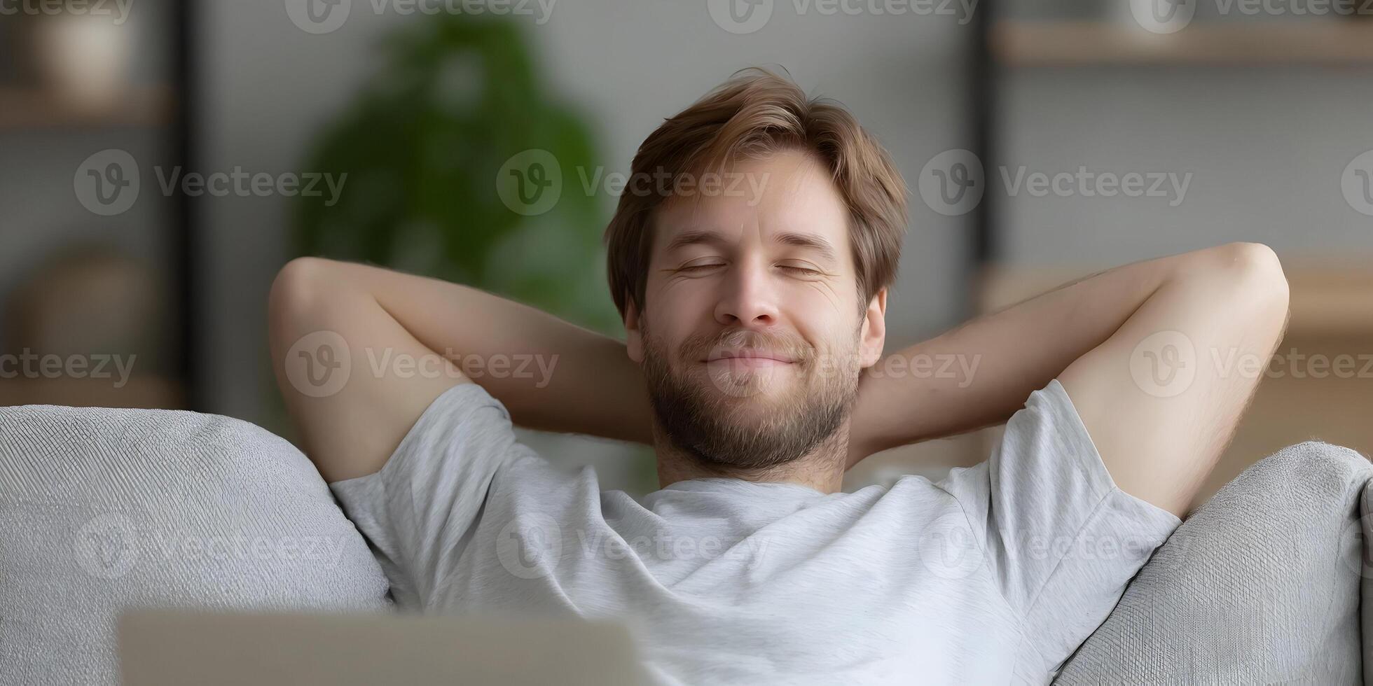 Happy Relaxed Man Resting on Couch Smiling Calm Peaceful photo