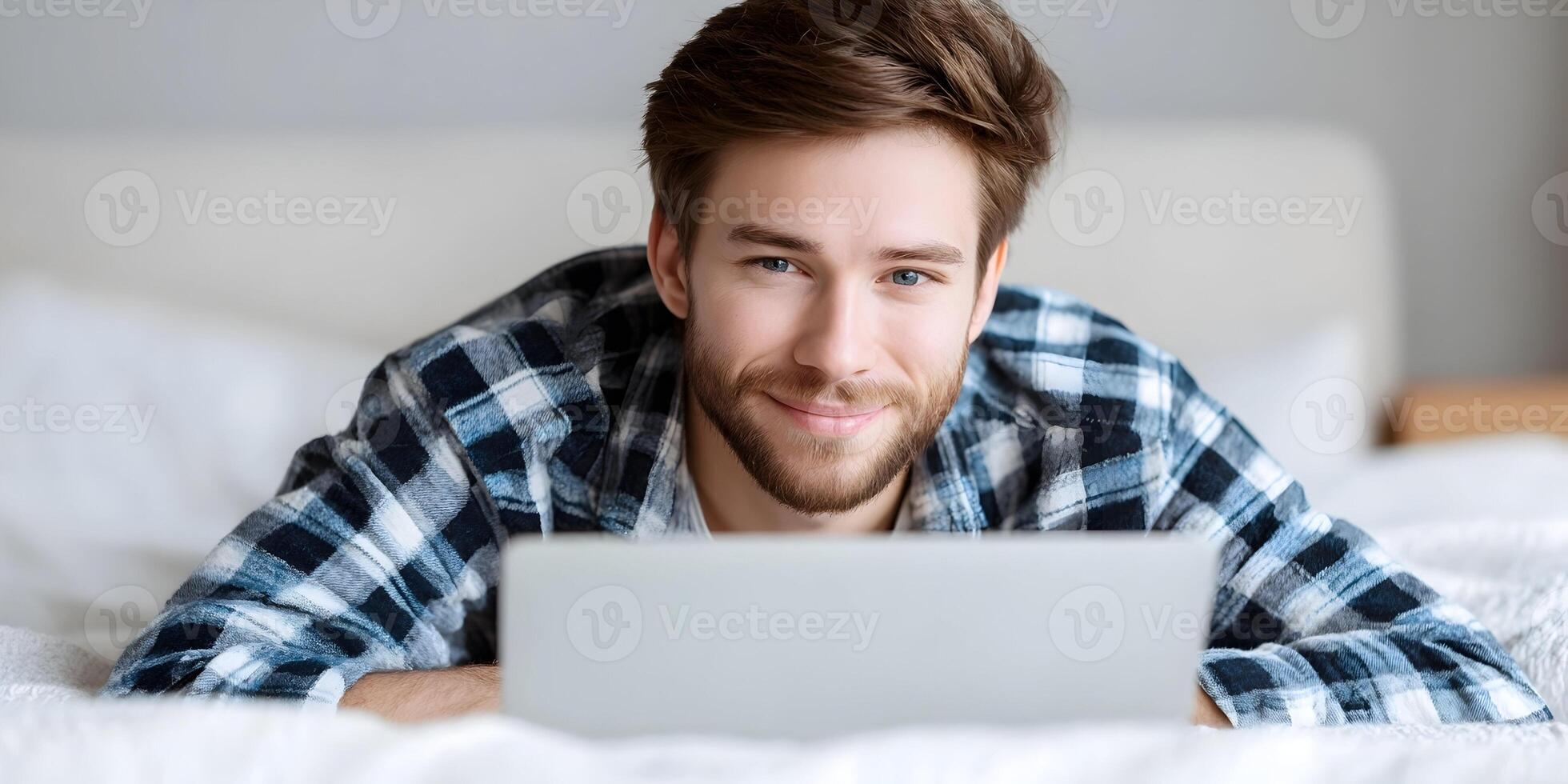 Smiling Man Lying in Bed Using Laptop Computer Happy Person Relaxing on Bedding Modern Technology Home Lifestyle photo