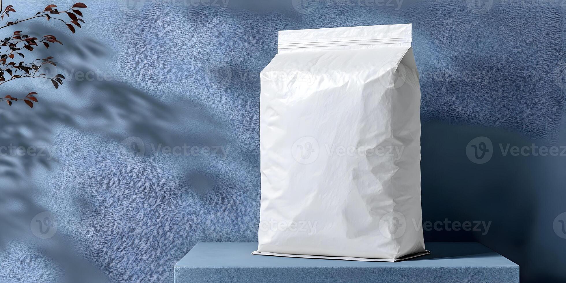 White Paper Pouch Mockup on Blue Surface with Plant Shadow photo