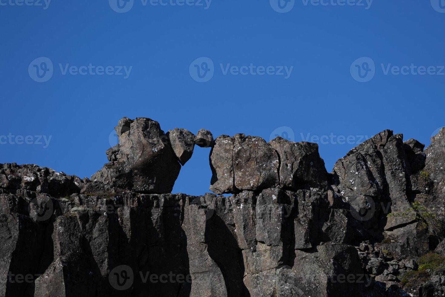 Unique Natural Rock Formation Under Clear Blue Sky in Daylight photo