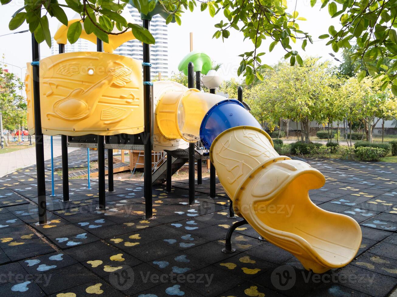 Children playing colorful slide playground urban park daytime eye-level fun and adventure photo