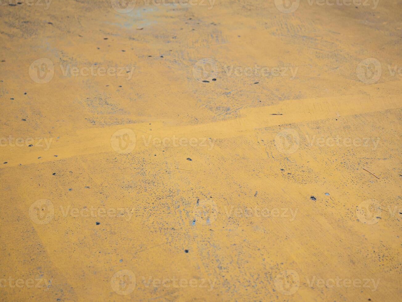 Exploring the textured surface of yellow concrete urban environment abstract imagery ground level perspective artistic expression photo