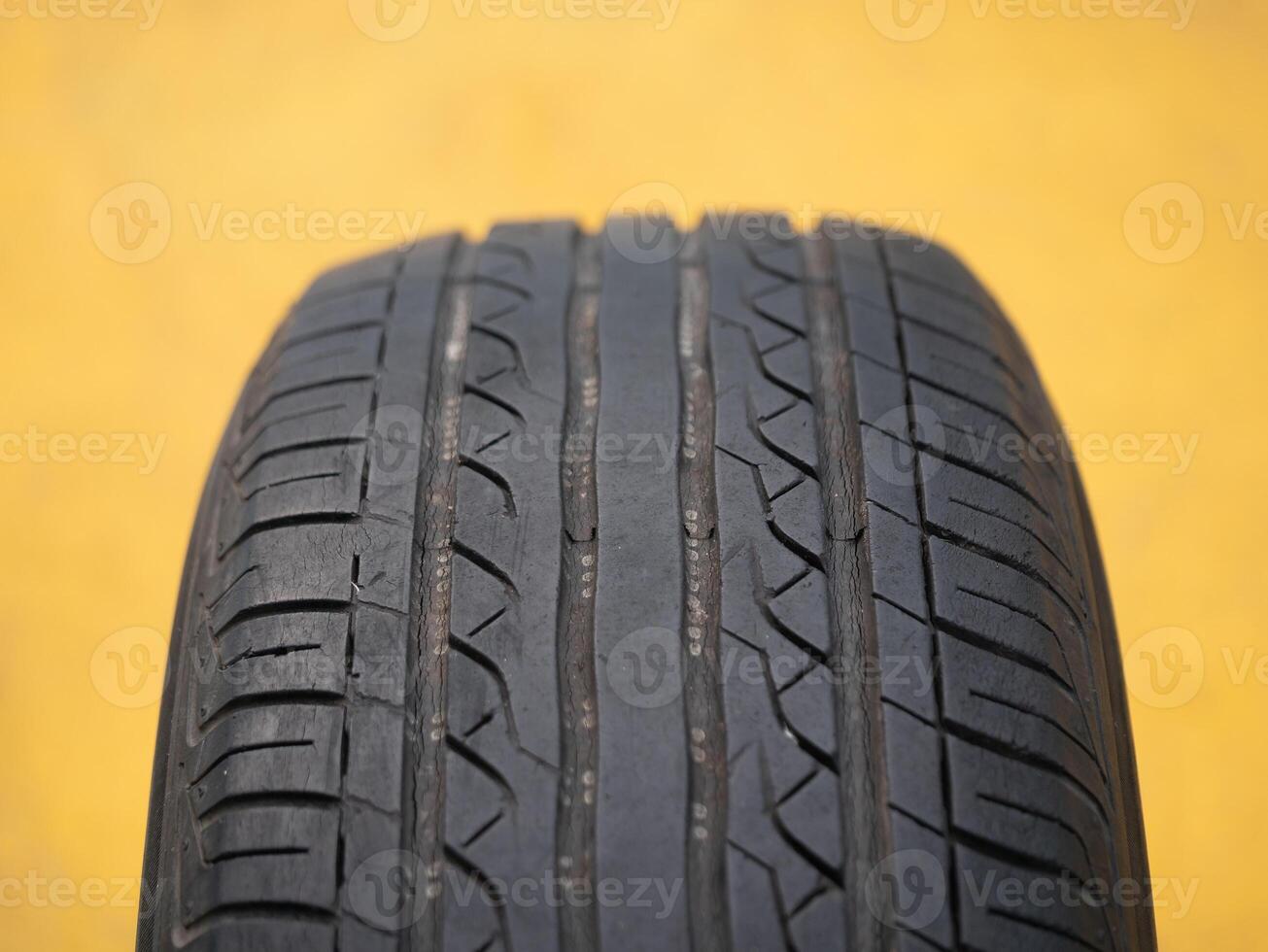 Examining tire tread patterns automotive workshop close-up image industrial environment detailed view vehicle safety insights photo