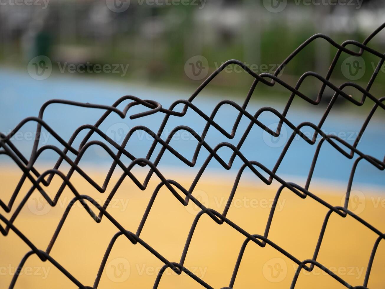 Close-up of twisted wire fence outdoor sports court photography urban environment ground level abstract concept photo