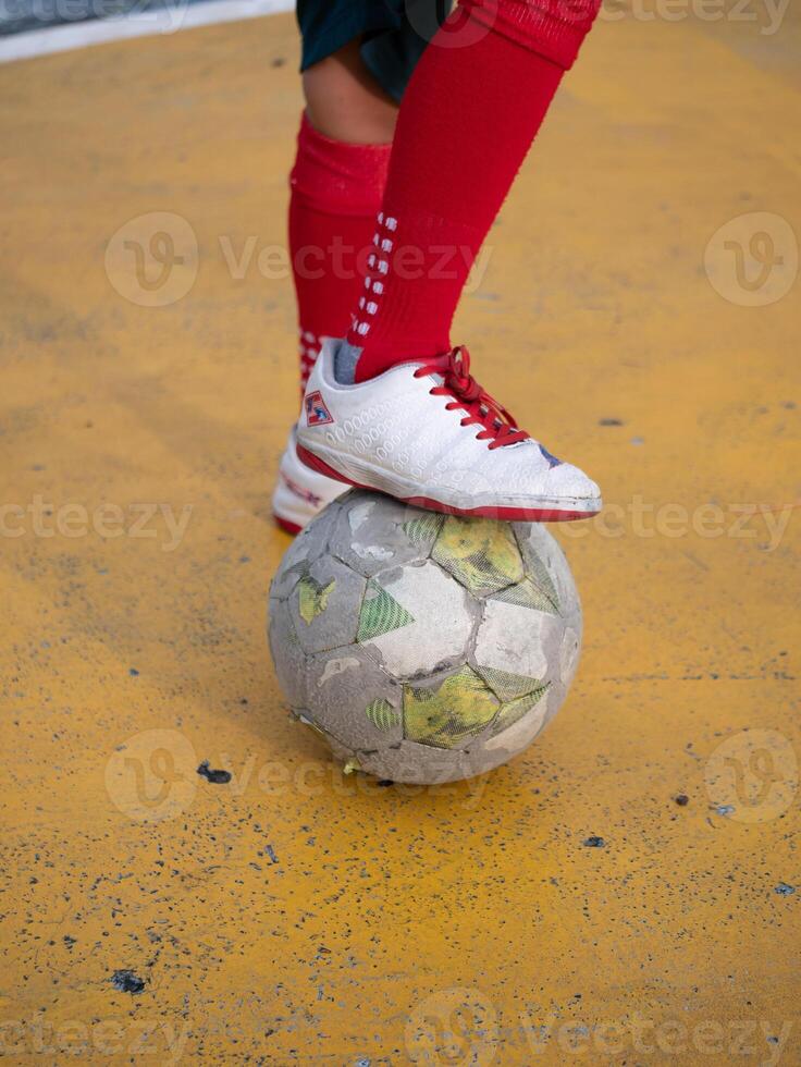 Soccer player balancing on ball urban playground sports action colorful environment dynamic viewpoint athletic skill showcase photo