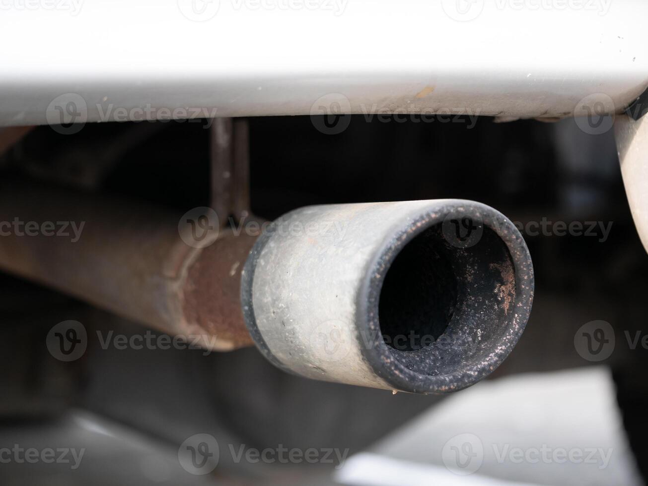 Vehicle exhaust pipe close-up industrial area photo urban environment macro view automotive maintenance insight