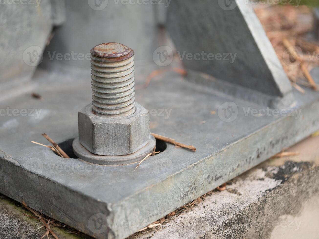 Industrial action close-up of rusty bolt on metal base construction site detailed image urban environment macro perspective photo
