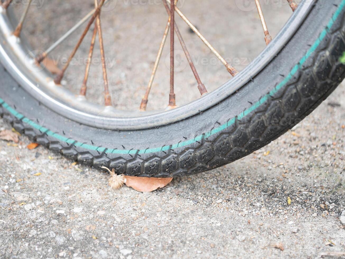 Flat bicycle tire urban street close-up photography city environment ground level transportation maintenance photo