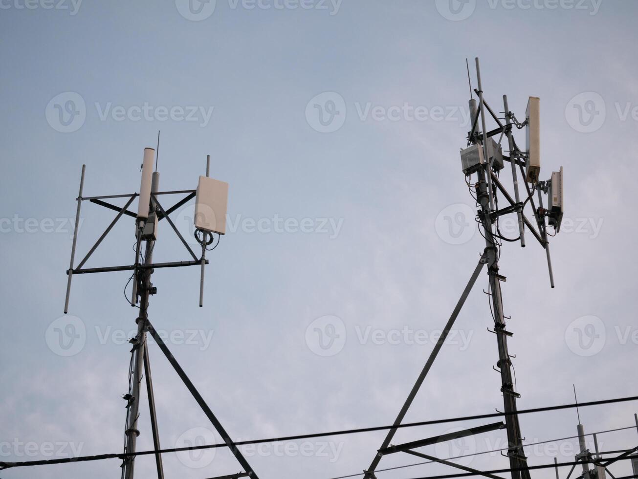 Telecommunication towers in urban sky technology infrastructure industrial setting evening light modern connectivity concept photo