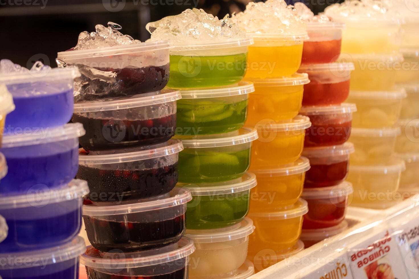 Colorful gelatin cups for sale at a local market vibrant display food stall outdoor setting eye-level view treats for all ages photo