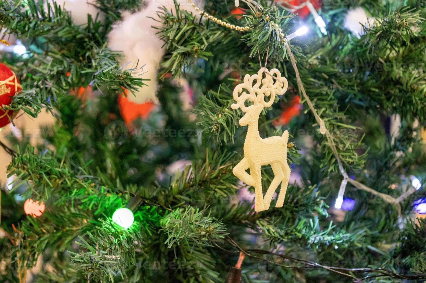 Festive christmas tree decoration featuring reindeer ornament cozy living room holiday content warm environment close-up view celebration concept photo