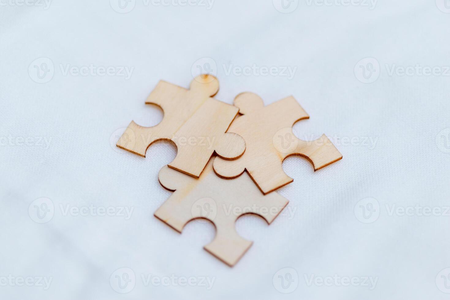 Business puzzle solving event creative workspace wooden pieces collaborative environment close-up viewpoint team dynamics photo