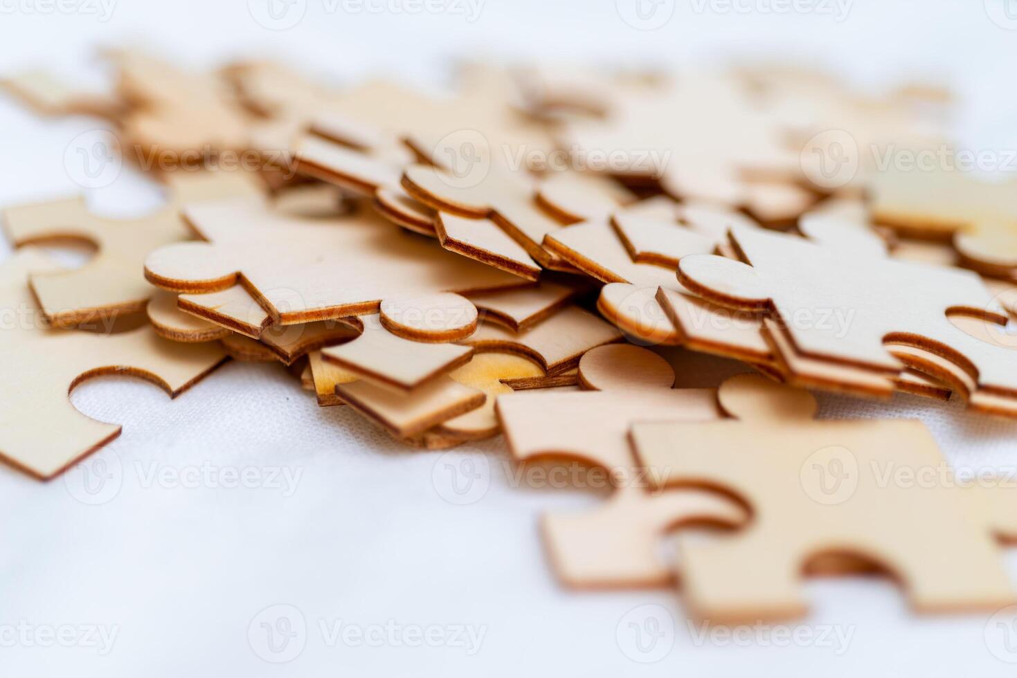 Puzzle pieces scatter on surface business strategy creative mindset indoor workspace close-up view problem-solving concept photo