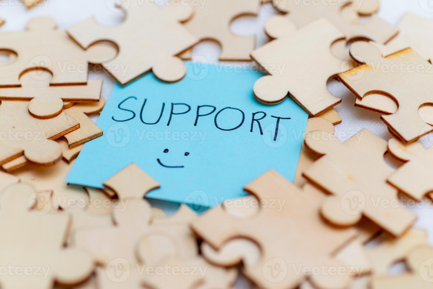 Boosting business support with puzzle pieces office setting visual content bright environment close-up collaboration concept photo