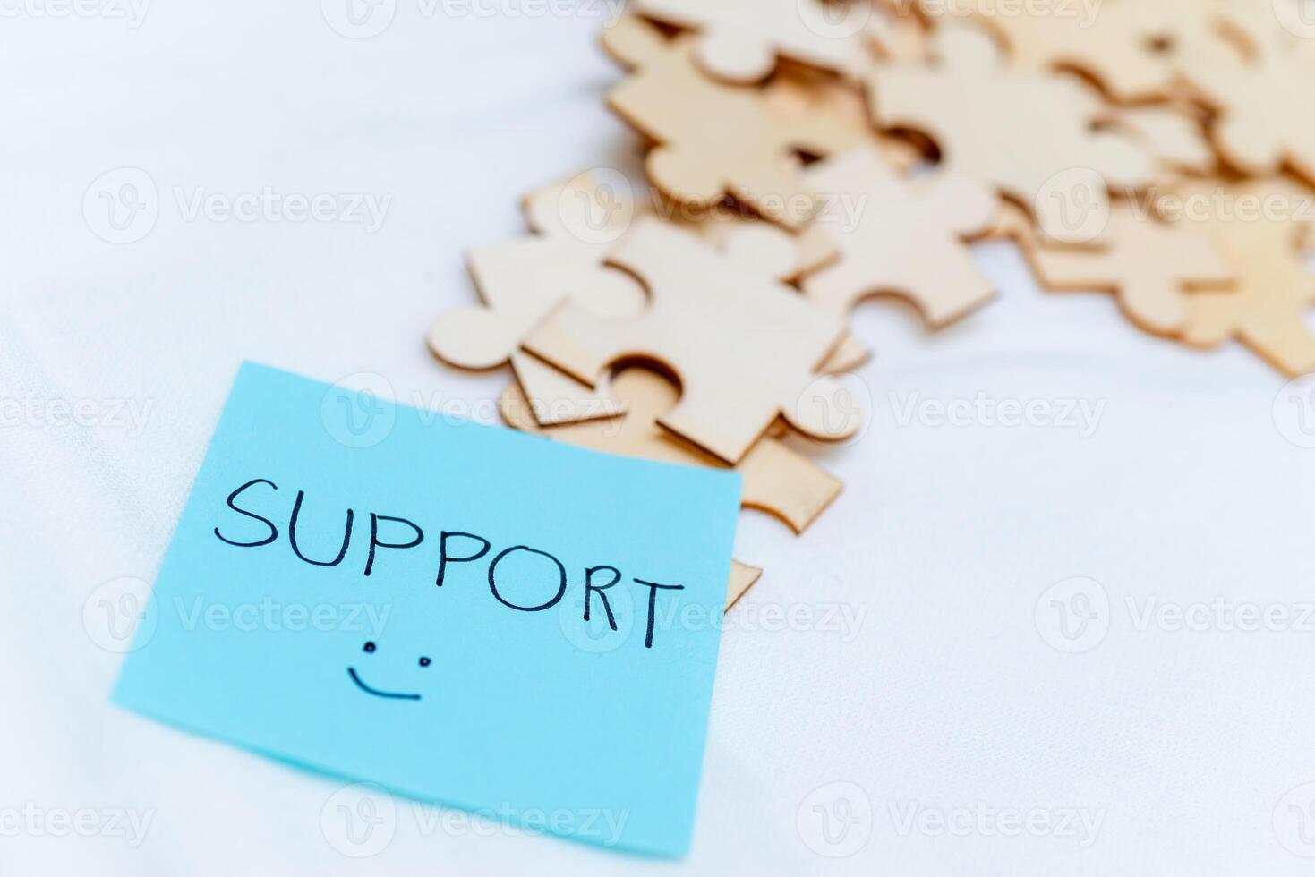 Business support puzzle pieces office desk digital note organized environment close-up view teamwork concept photo