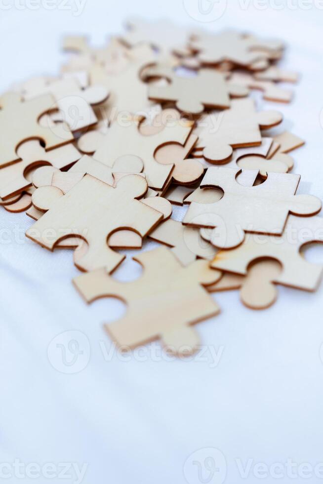 Business strategy puzzle pieces on white cloth indoor workspace photo composition soft lighting conceptual thinking
