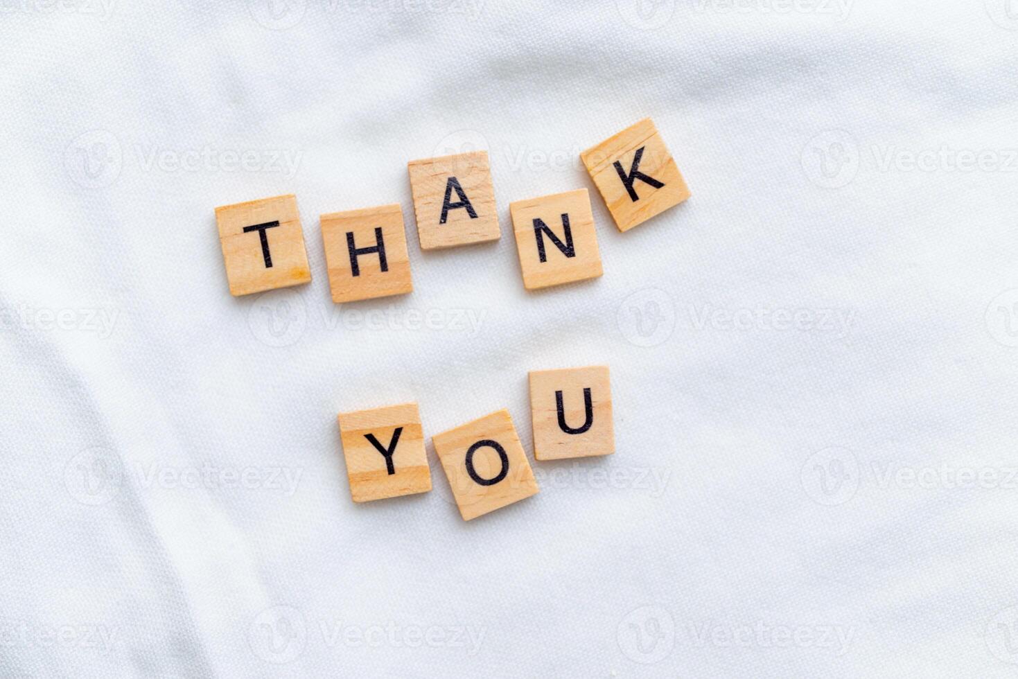 Gratitude expression in business context office setting wooden blocks minimalist environment close-up view emotional impact photo