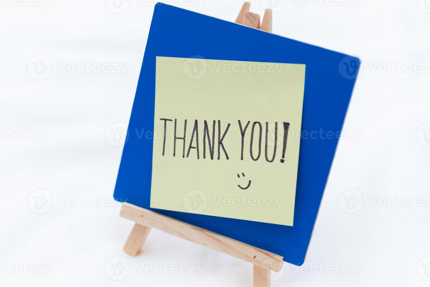 Thank you note displayed on easel business setting positive emotions minimalist environment close-up view gratitude concept photo