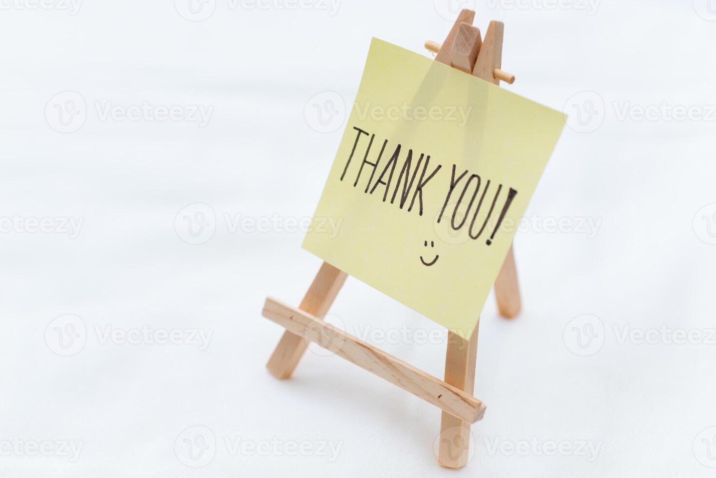 Thank you note on mini easel home office appreciation gesture minimalist setup close-up view business gratitude concept photo