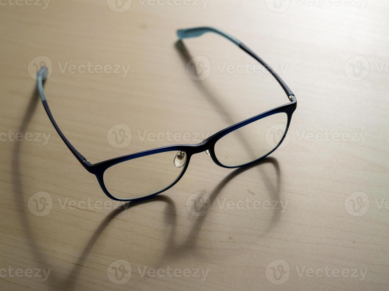 Minimalistic stylish eyeglasses on wooden table a modern living fashion concept photo