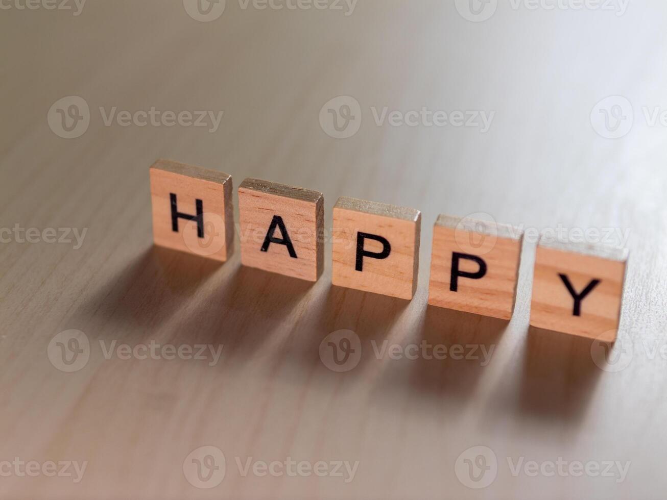 Happy moments captured wooden blocks spell joy in minimalist workspace setting photo