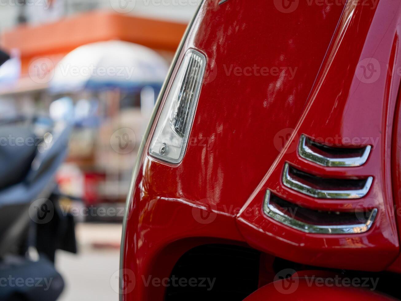 Vibrant red scooter showcase urban setting focused close-up modern design concept photo