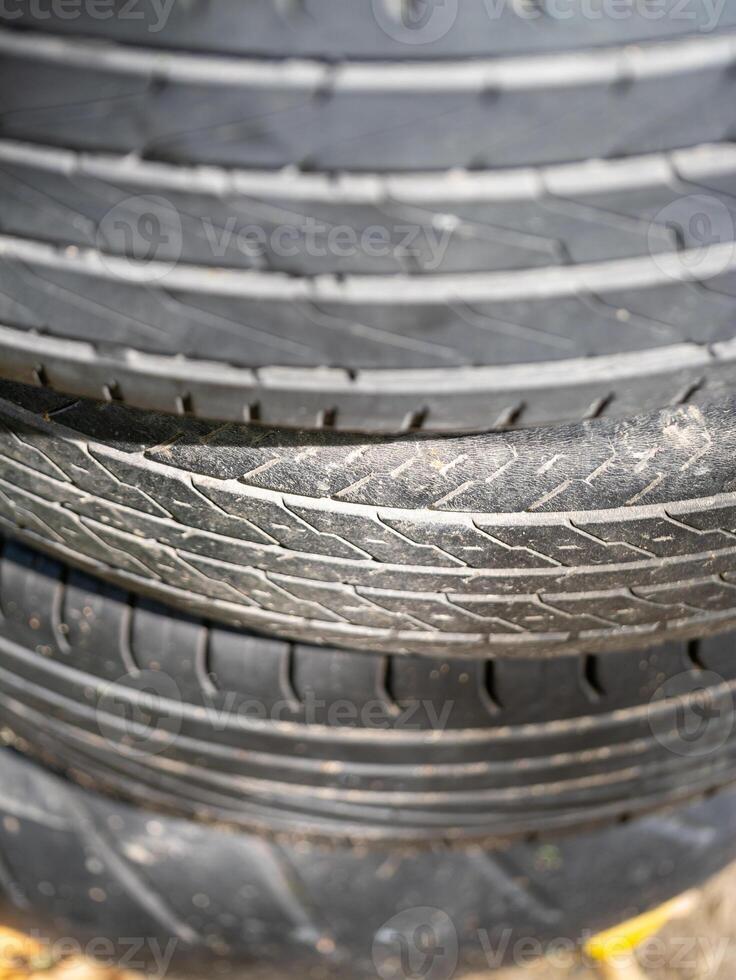 Automotive workshop close-up detailed inspection of stacked tires in industrial setting photo