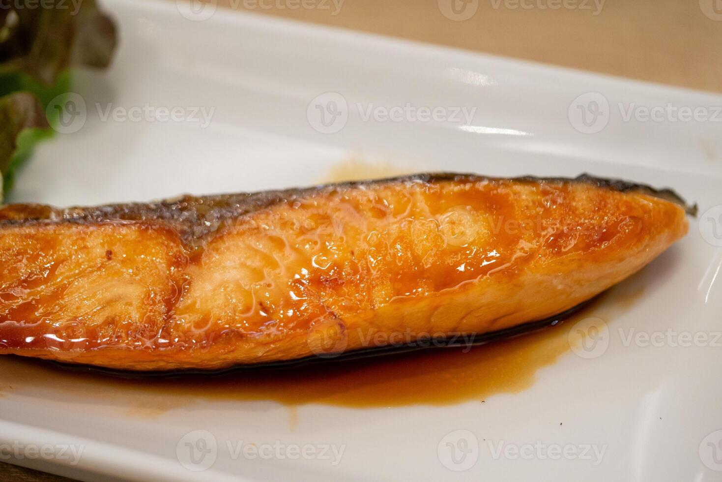 Grilled salmon dish restaurant food indoor setting close-up culinary delight photo