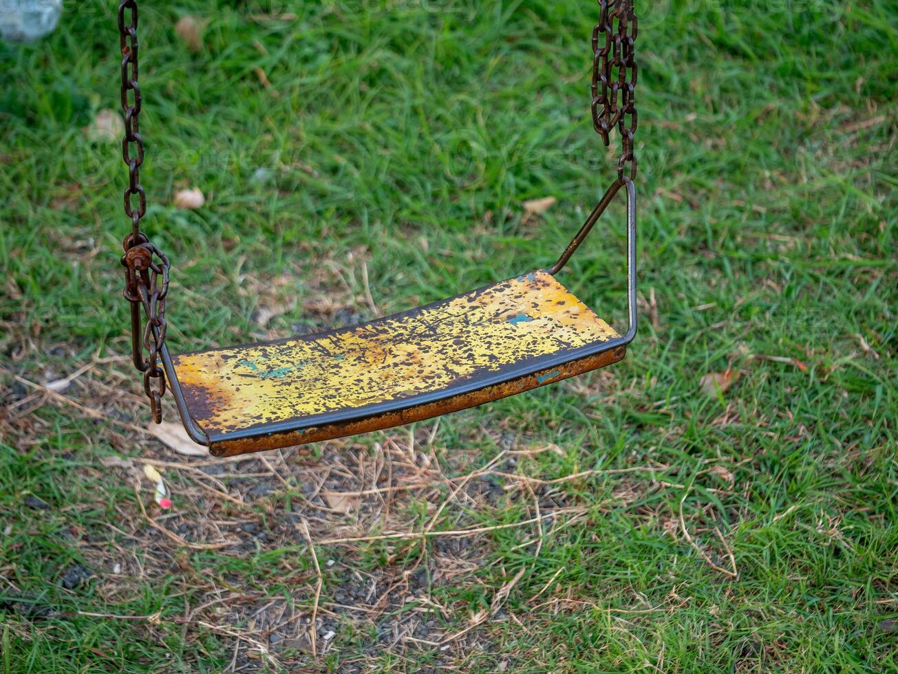 Swing set in abandoned park outdoor playground nostalgic environment close-up view photo