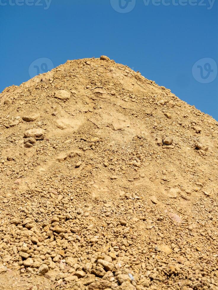 Desert construction soil stockpiling under a clear blue sky at ground level photo
