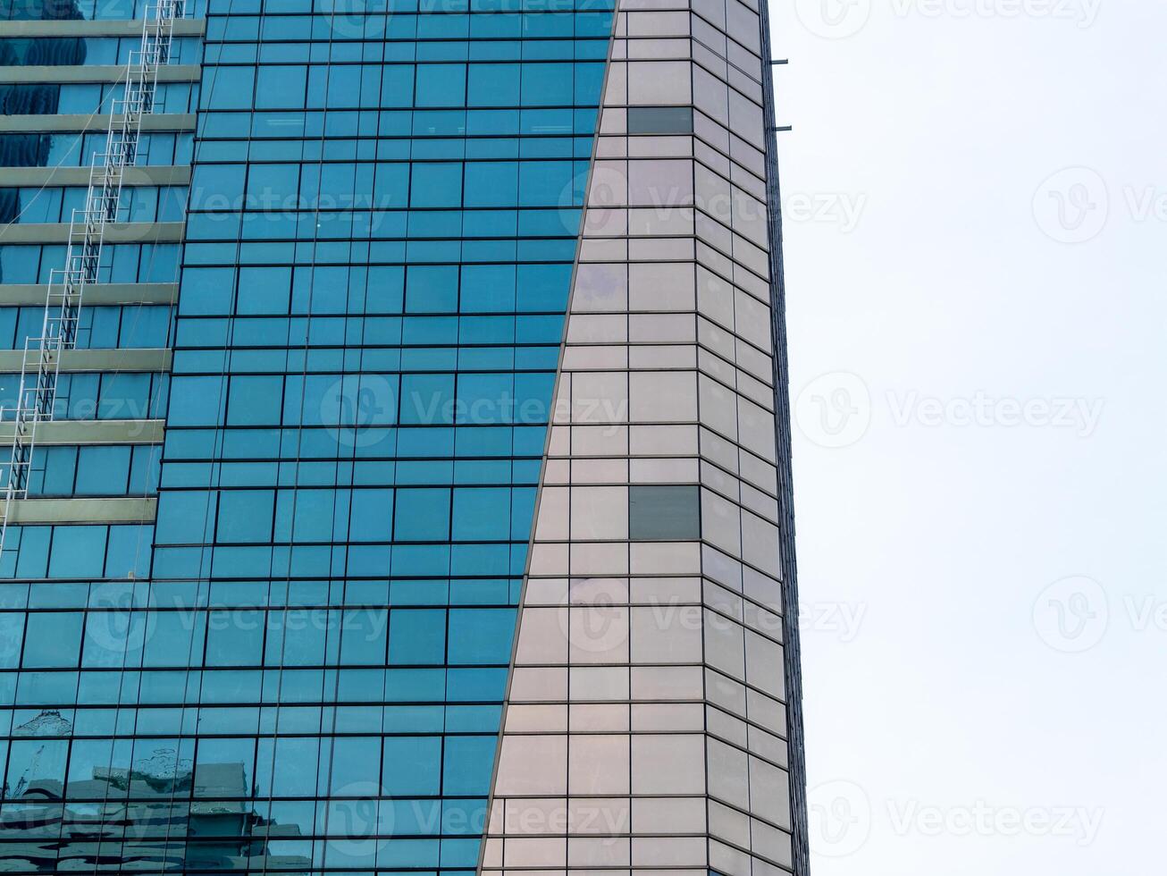 Modern skyscraper reflection urban city architectural glass facade vertical view contemporary design photo