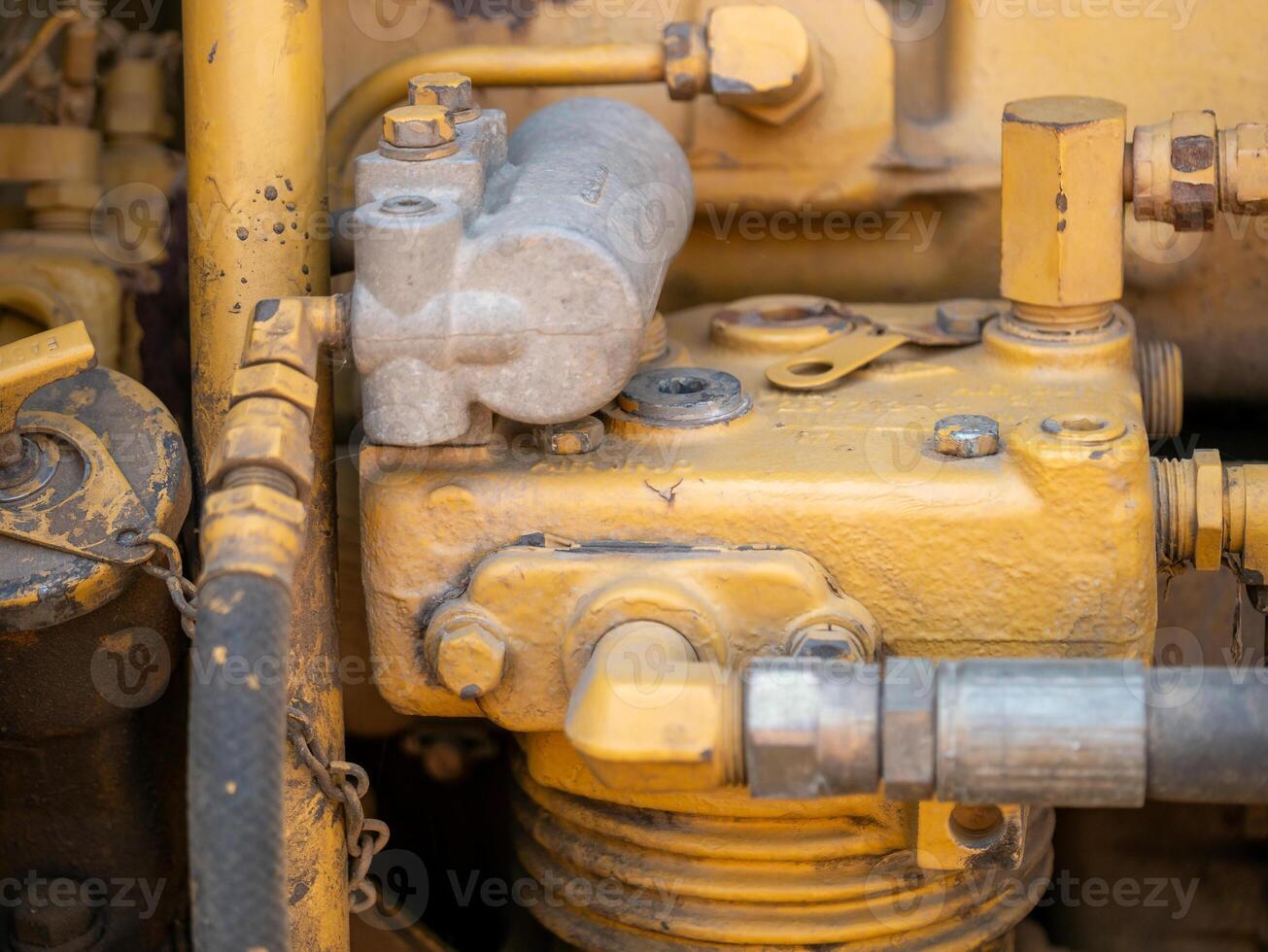Industrial machinery close-up view of yellow engine components at construction site photo