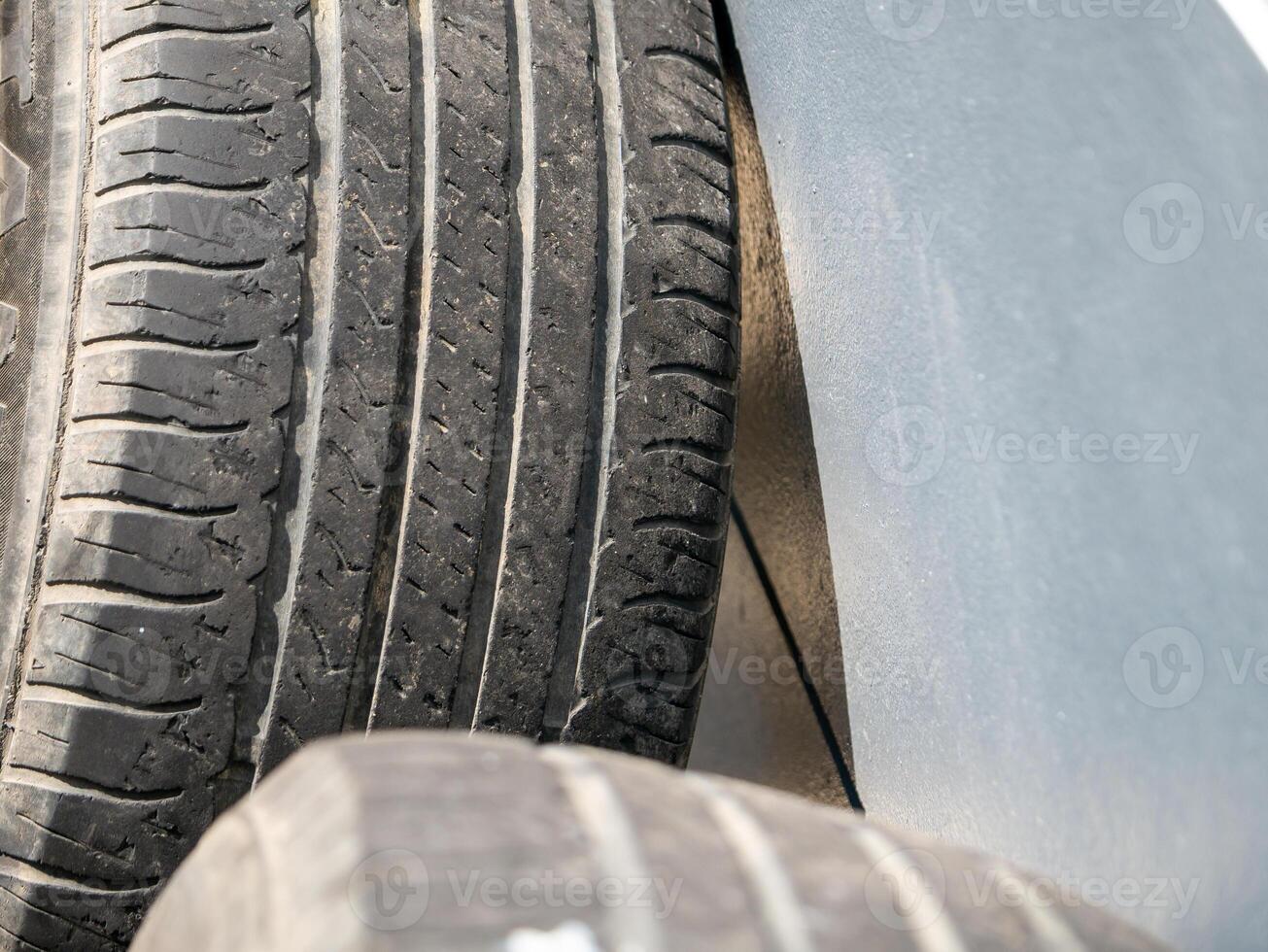 Inspecting vehicle tires for safety auto repair shop indoor close-up maintenance photo