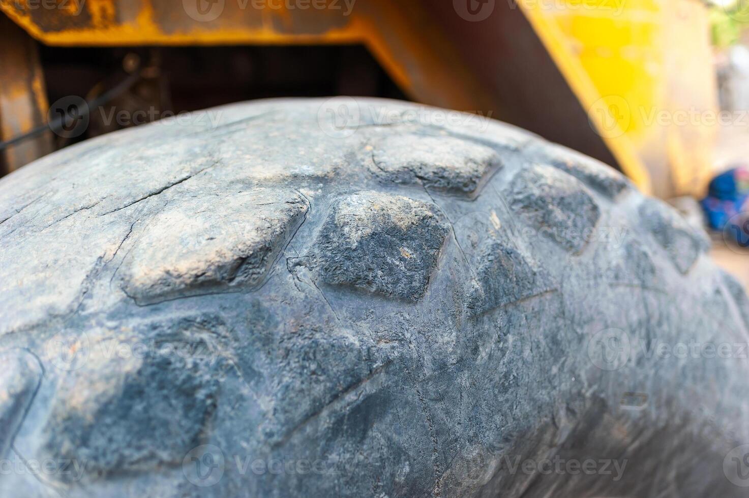 Heavy machinery action close-up of tire tread in industrial site photo