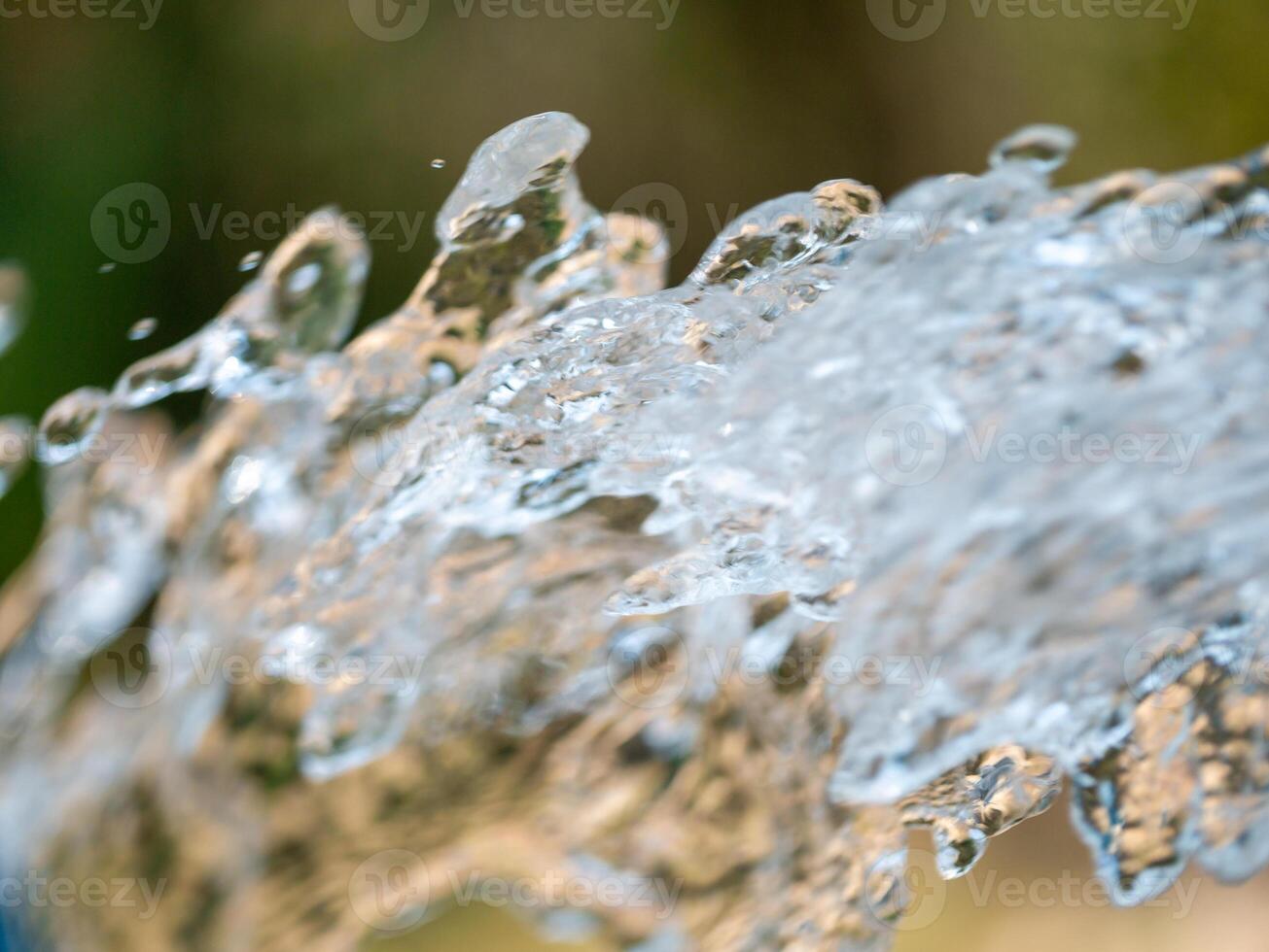 Close-up dynamics of flowing water in a natural outdoor environment photo