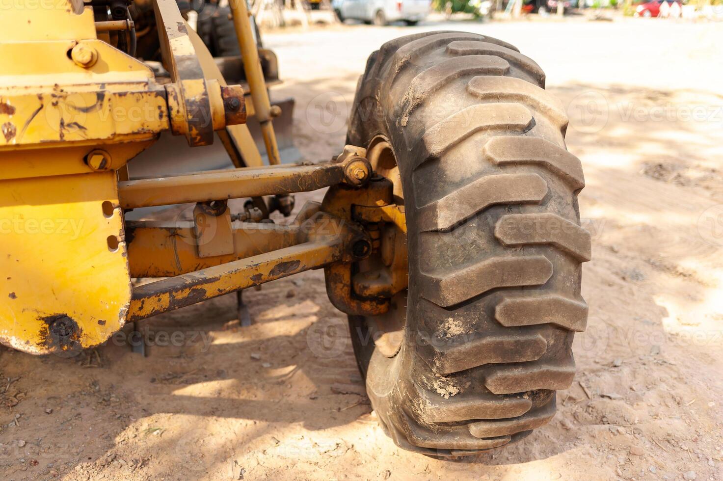 Construction vehicle tire close-up job site machinery outdoor ground level industrial details photo