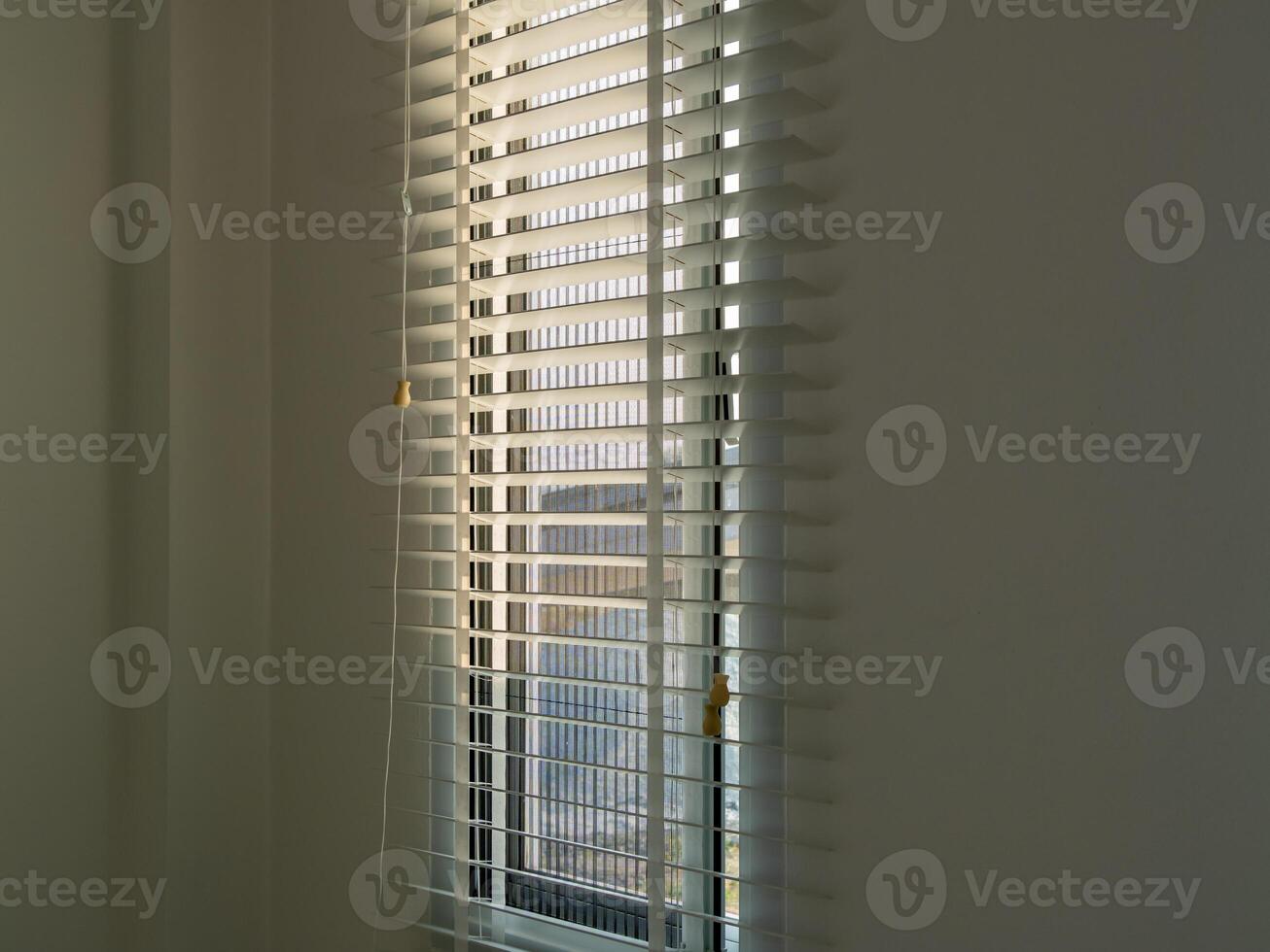 Urban morning sunlight streaming through blinds close-up view of serenity and brightness photo