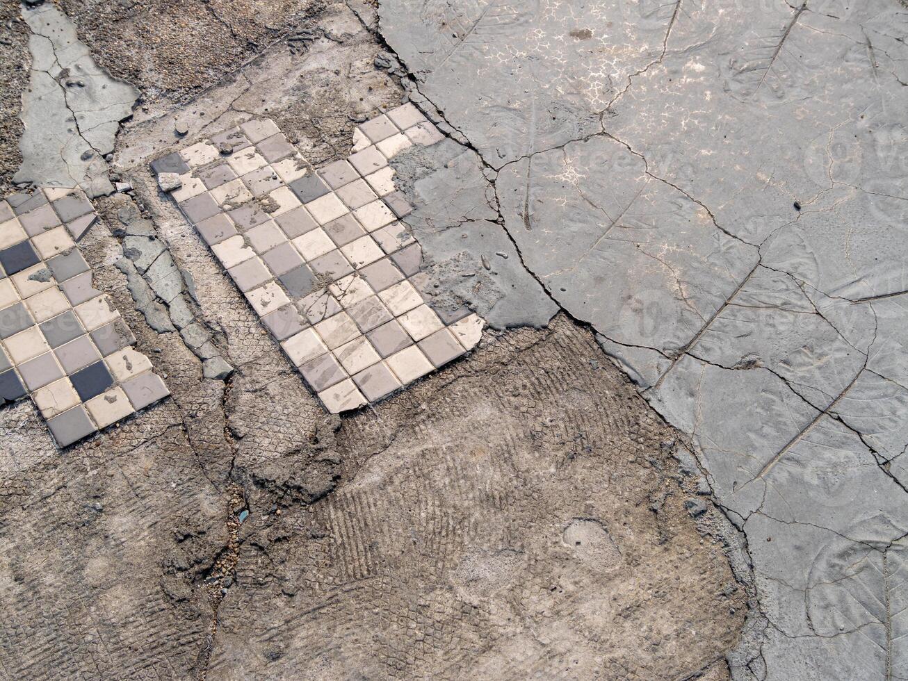 Cracked concrete with tile patterns urban area infrastructure detail aerial view urban decay photo