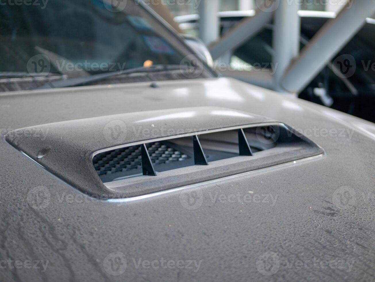 Performance concept car engine hood scoop in detailed automotive workshop setting photo