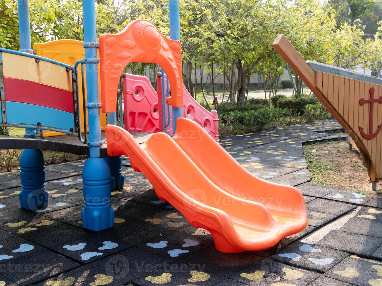 Children playing colorful playground slide park outdoor activity sunny day close-up view joyful fun photo