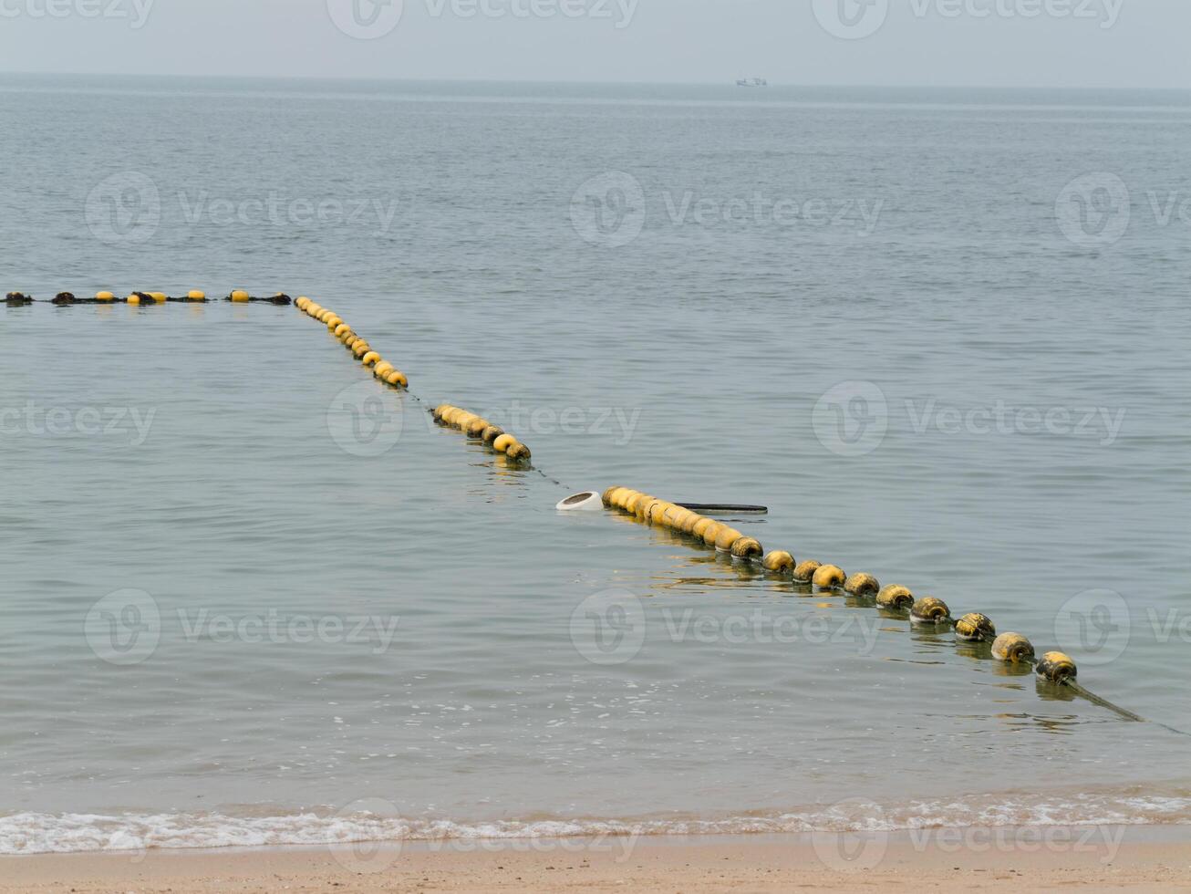 Floating barrier at shoreline coastal area nature calm waters close-up environmental protection photo